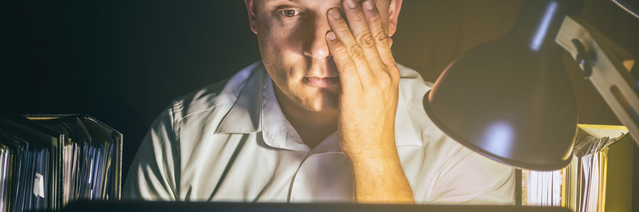 main image - Man with tired eyes due to too much work on the computer screen